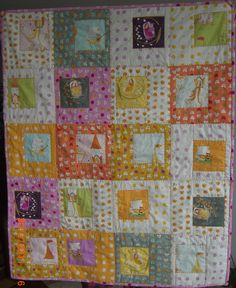 a baby quilt is hanging on the wall