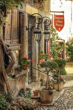 an old building with potted plants outside