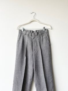 A pair of 1990s grey suit pants. Straight leg- mid rise. Zipper and latch button closure at waist. Brand is colter Waist 28 rise12 hips inseam 28 outer39.5 Gray High-waisted Pants With Belt Loops, Tailored Gray High-waisted Pants, Tailored High-waisted Gray Pants, Gray High Waist Bottoms With Belt Loops, Gray Bottoms With Button Closure For Spring, Gray Flat Front Pants For Business Casual, Gray Bottoms With Button Closure For Work, Gray Straight Pants With Belt Loops, Classic Gray Wide Leg Bottoms