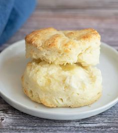 two biscuits sitting on top of a white plate