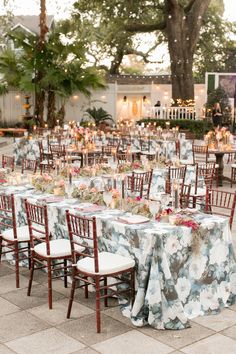 an outdoor wedding reception set up with tables and chairs