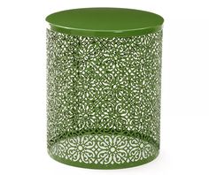 a green table with an intricate design on the top and bottom, in front of a white background