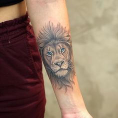 a woman with a lion tattoo on her arm