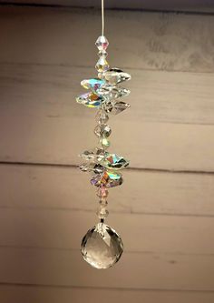 a glass wind chime hanging from a ceiling