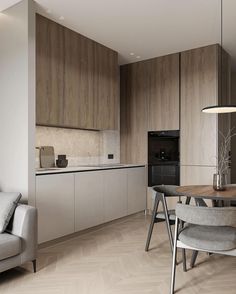 a modern kitchen and dining room with wood paneling on the walls, white cabinets and grey chairs