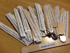 several wooden spoons with labels on them sitting on a table next to a knife