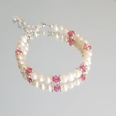 "This beautiful Pearl Bracelet for Newborn, Infant, Baby or Little Girl is made with 4mm Freshwater Pearls, Swarovski Bicones and sterling silver Daisy spacer beads. It includes a \"Grow with Me\" extender chain. S I Z I N G    G U I D E The bracelet should be 3/4\" larger than the child's snug wrist measurement. If you are unable to measure, you may use this guide for approximate bracelet sizing. 0-3 Months; 4\", 3-9 Months; 4.5\", 9-36 Months; 5\", 3-5 Years; 5.5\", 5-8 Years; 6\", 8-12 Years; 6.5\", 13+ Years; 7\", Other options available on request. PLEASE NOTE; Design is modified according to size." Round Beads Birthstone Bracelets For Birthday, Round Beaded Birthstone Bracelets For Birthday, Birthstone Bracelets With Round Beads For Birthday, Hypoallergenic Pearl Bracelet For Birthday, Adjustable Hypoallergenic Pearl Bracelet For Birthday, Hypoallergenic Adjustable Pearl Bracelet For Birthday, Beaded Pearl Bracelet For Birthday, Adjustable Pearl Beaded Bracelet For Birthday, Adjustable Pink Jewelry For Baptism