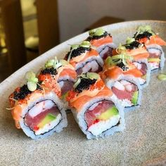 several sushi rolls are arranged on a plate