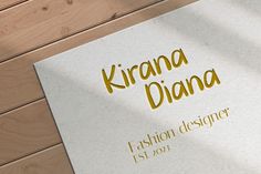 the cover of a fashion designer's book on a wooden floor with wood planks