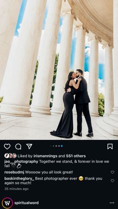 two people standing next to each other in front of pillars