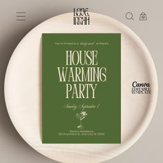 a white plate with a green cover on it and the words house warming party written in cursive font