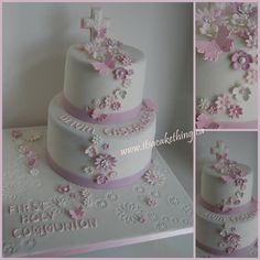 the cake is decorated with pink and white flowers on it's sides, along with a cross