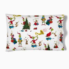 a white pillow with dr seuss's christmas tree and other characters on it