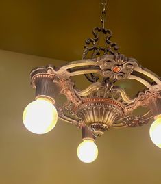 a chandelier hanging from the ceiling with three light bulbs on each one side