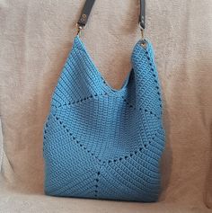 This is a high quality dark blue crocheted bag. The bag is completely made by hand. This fashionable bag will become an indispensable part of your wardrobe, suitable for any look and occasion. This wonderful handmade crocheted bag is the perfect accessory and a great gift for any holiday for your mother, sister, friend. Crochet gives the bag a soft, lightweight texture. Pleasant to the touch, a knitted bag is an excellent choice for any weather and any time of year. It has enough space to store your belongings and is not too small and not too big. To make knitted bags, we use both new and recycled materials of good quality, which allows us to respect the environment. Materials: cotton Cotton lining Lined pockets without fastening Height - 42 cm / 16,5 inch Width - 28 cm / 11 inch Detachabl Everyday Square Blue Hobo Bag, Everyday Blue Square Hobo Bag, Bohemian Blue Hobo Tote Bag, Handmade Crochet Hobo Bag For Everyday Use, Handmade Hobo Crochet Bag For Everyday Use, Blue Crochet Bag For Everyday Use, Blue Crochet Shoulder Bag For Travel, Blue Crochet Shoulder Bag For Vacation, Blue Handwoven Crochet Bag For Vacation