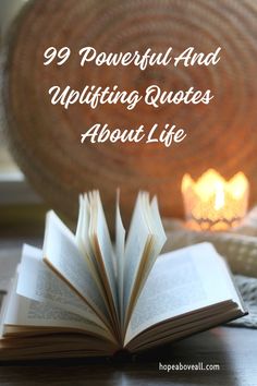 an open book sitting on top of a wooden table next to a candle and wicker basket