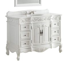 a white bathroom vanity with drawers and a sink