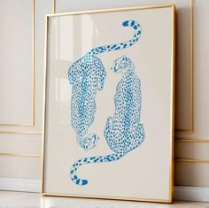 two cheetah are shown in blue ink on a white background with gold trim