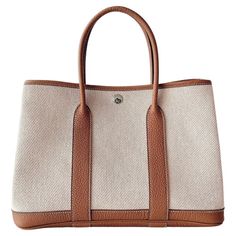 HERMES GARDEN PARTY 30 IN ECRU CANVAS AND ABRICOT NEGONDA LEATHER. We have a elegant Hermes Garden Party 30 In Ecru Twill H Canvas and Abricot Negonda. It is an elegantly simple bag with a sportier more casual look given by the beautiful canvas finish. This beautiful shade of neutral perfection, and is the perfect tote bag. Ecru Canvas & Abricot Negonda Inside Dimensions: L 30 x H 21 x D 13 cm Condition: very good with hermes box Hermes Garden Party 30, 2022 Handbag, Hermes Garden Party, Simple Bag, Dream Bags, Hermes Kelly Bag, Hermes Box, Shopping Photography, Cartier Love