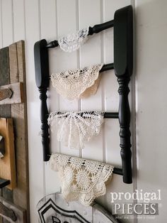 there are three crocheted laces hanging on the wall