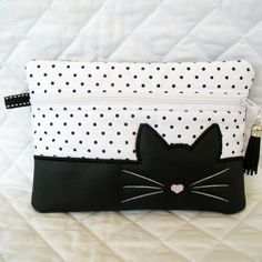 a black and white purse with a cat on it