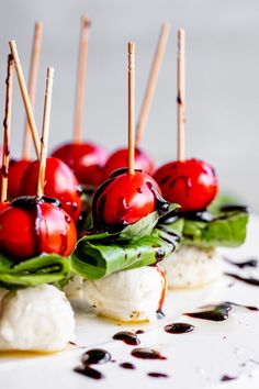 small appetizers with cherries and mozzarella are arranged on a plate