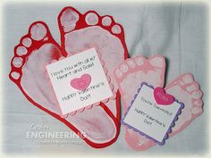 two pairs of pink and red baby feet with tags attached to the toes that say happy valentine's day