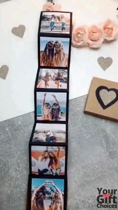 a stack of cards with pictures on them next to a box and some hearts in the background