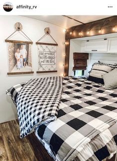 a bed with black and white checkered comforter in a small room that is decorated with string lights