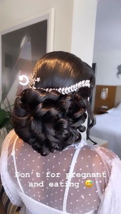 the back of a woman's head wearing a wedding hair comb