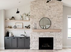 a living room filled with furniture and a fire place in front of a brick fireplace