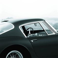 a black and white photo of a classic car