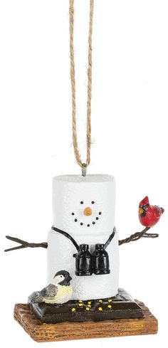 a snowman ornament with two birds on it