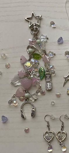 several charms are laying on a table together, including one with a phone and the other with a star