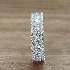 a diamond ring sitting on top of a wooden table