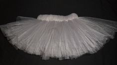 a white tulle skirt on a black background