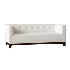 a white couch sitting on top of a wooden frame