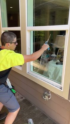 a man is painting the outside of a house