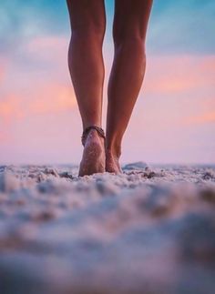 there is a woman's feet in the sand