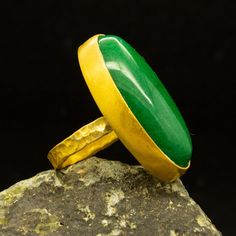 Green Jade Ring | 24K Gold Plated | Handmade Birthstone Ring | 925 Sterling Silver Ring | Good Luck Jewelry | Vintage Style Gift Our shop offer free ring sizing Handcrafted hammered ring Metal : 925 Sterling Silver Plating : 24K Gold Band Width : 3 mm Gem Stone : Jade Gem Size : 30 X 15 mm Ring Weight : 11.4 grams Ring Size : US 6 (The size you want is made for free). (We used the US standard sizing) **Custom Orders is Made** As pellada family, we will be happy to help you if you contact us with Gold Emerald Ring Untreated For Gift, Unique Handmade Gold Emerald Ring, Handmade Gold Oval Emerald Ring, Green Jade Ring, Hammered Jewelry, Green Emerald Ring, Zierlicher Ring, Gold Armband, Hammered Rings