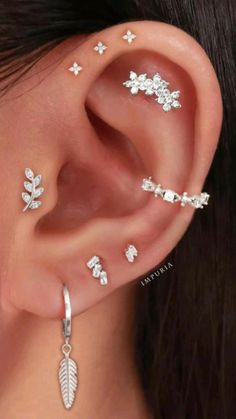 a woman with three different piercings on her ear