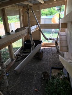 the inside of a chicken coop with hammocks and ladders on the floor