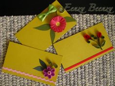 two yellow envelopes with flowers on them