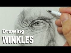 a person drawing an eye with a pencil