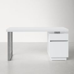 a white desk with two drawers on the bottom and one drawer at the top, in front of a plain wall