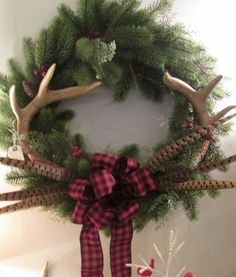 a christmas wreath with deer antlers on it