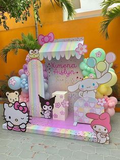 a hello kitty birthday party with balloons and decorations