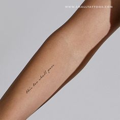 a person with a tattoo on their arm that says, believe we are all here