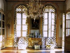 an ornately decorated room with chandelier and windows