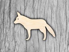 a wooden cutout of a fox on a wood background